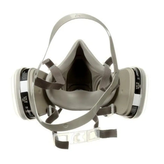 A gray full-face respirator mask with two attached cylindrical filter canisters and gray straps, shown on a plain white background.