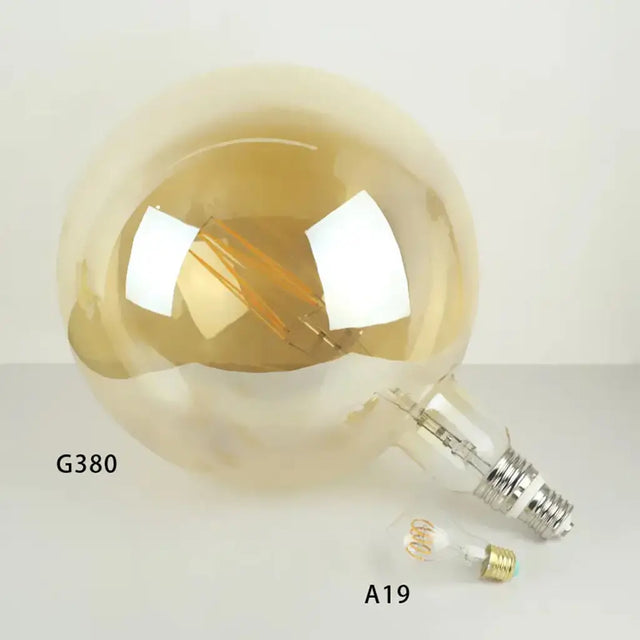 Gold reflective light bulb on a white background with 'G380' and 'A19' labels.