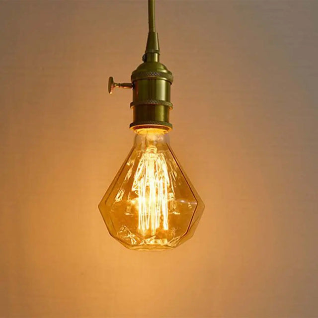 Vintage-style light bulb with a warm glow against a soft background