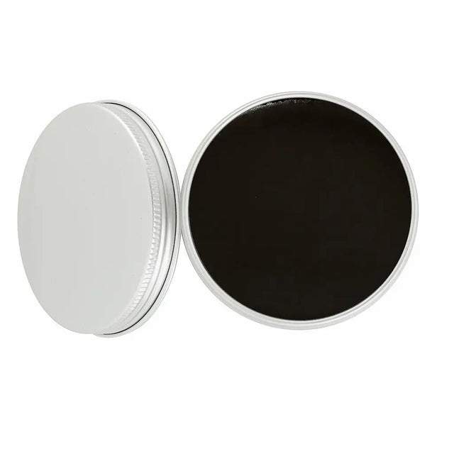 Round container with a silver lid and black interior on a white background