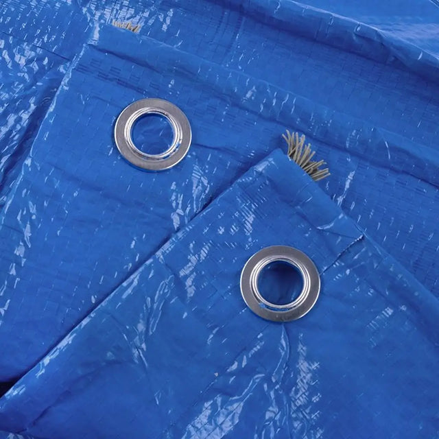 Close-up of a blue tarp with metal eyelets