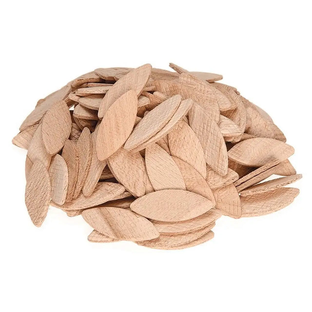 Pile of light brown pumpkin seeds on a white background