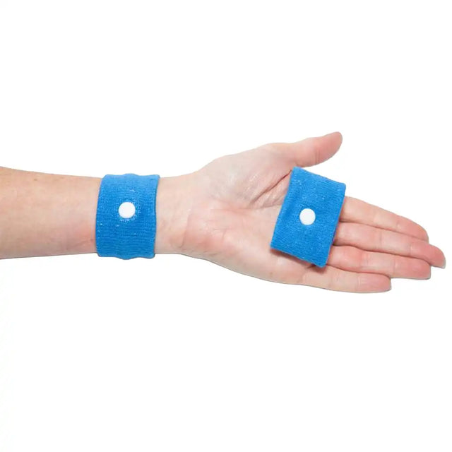 Blue wristbands with white buttons on a person's wrist and hand against a white background