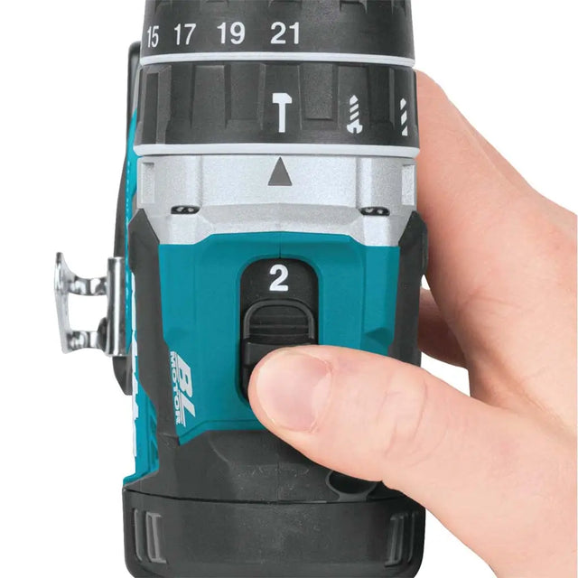 Hand holding a cordless drill with a focus on the chuck and trigger mechanism.