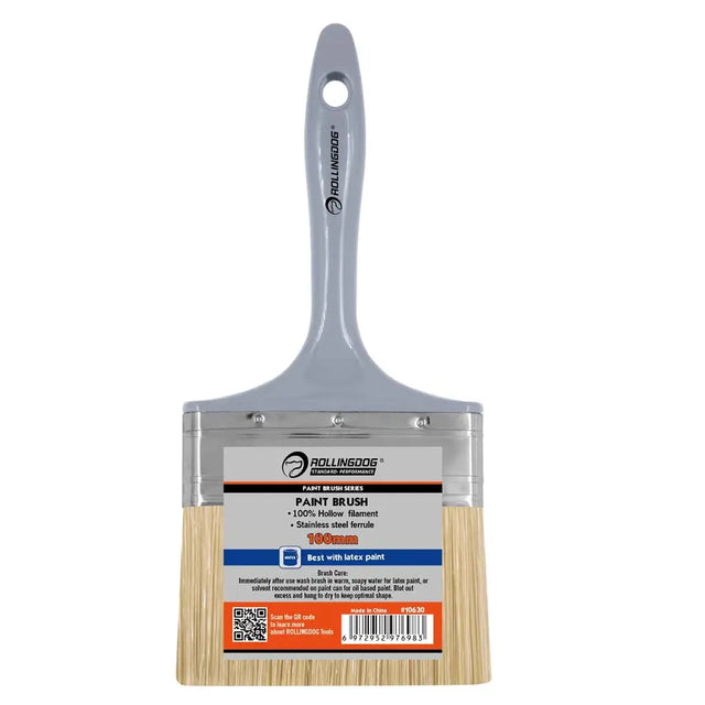 Paint brush with wooden handle and metal ferrule on a white background
