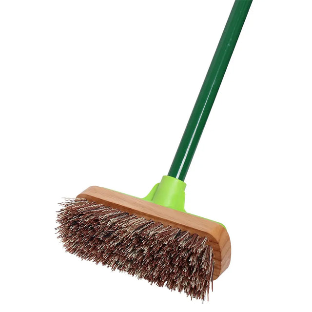Broom with wooden head and green handle on a white background