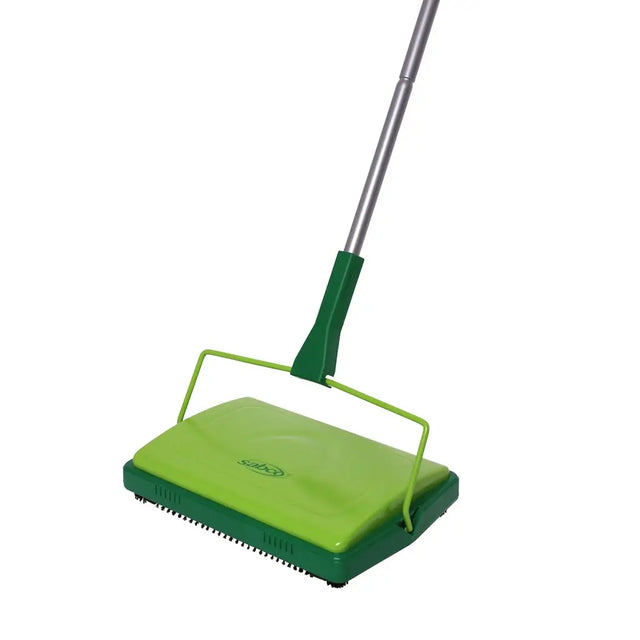 Green carpet sweeper with a long handle on a white background