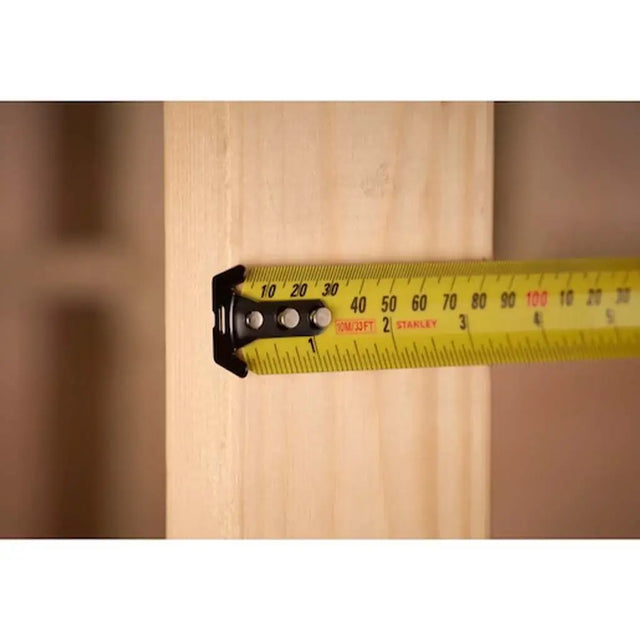 Yellow measuring tape on a wooden surface
