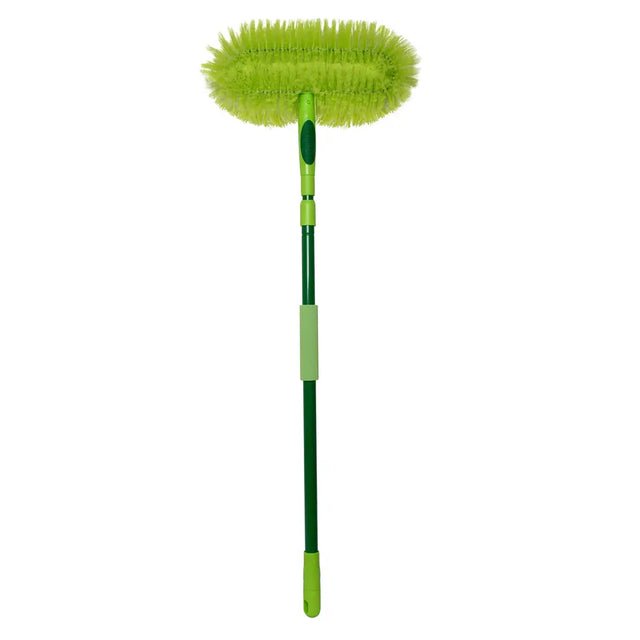 Green cleaning brush with a long handle on a white background
