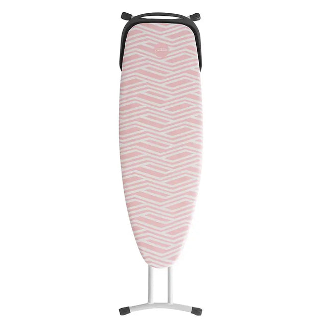 Pink and white zigzag patterned ironing board on a white background
