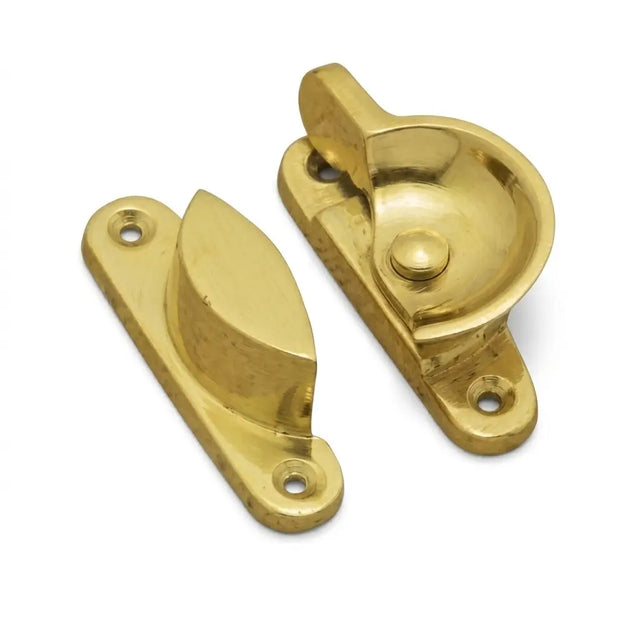 Pair of gold window sash locks on a white background