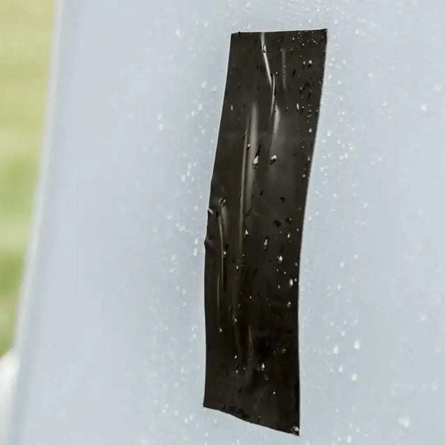 Black tape on a white surface with a blurred background