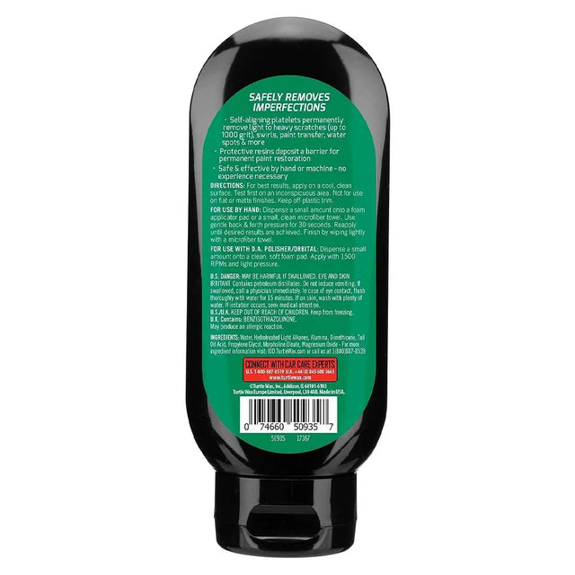 Back view of a black bottle with green label on a white background