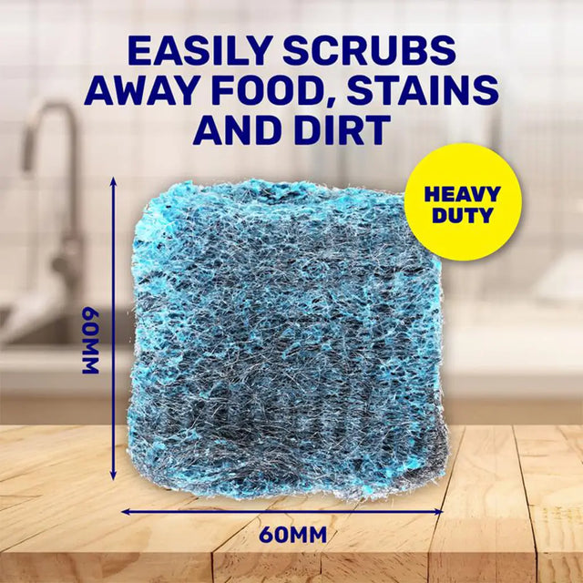 Heavy-duty cleaning sponge with text indicating its ability to scrub away food, stains, and dirt on a wooden surface.