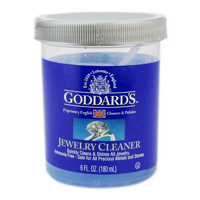Goddard's jewelry cleaner jar with blue liquid and silver lid on a white background