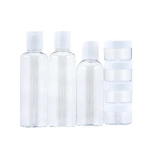 Set of four clear plastic bottles with white caps on a white background
