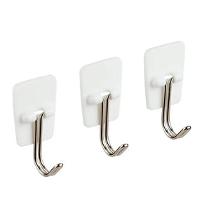 Three white hooks with metal hooks on a white background
