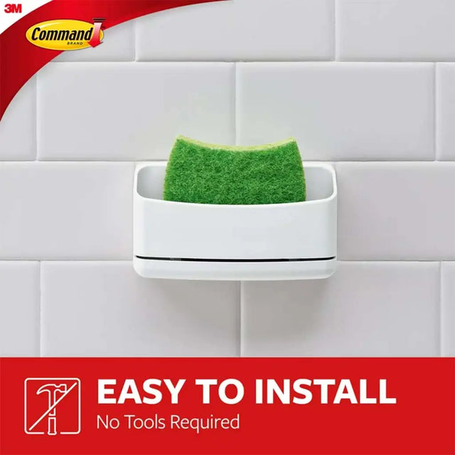 White sponge holder with a green sponge on a tiled wall, featuring 3M Command brand.