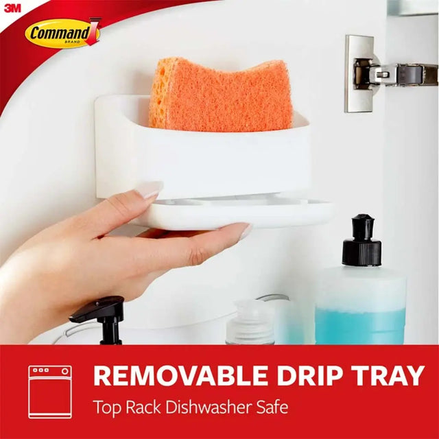 Hand placing a white container with a removable drip tray into a dishwasher, with 3M Command logo visible.