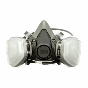A 3M dual-face mask with a gray and black central respirator body, two clear plastic filter canisters on either side, and black straps, shown on a plain white background.