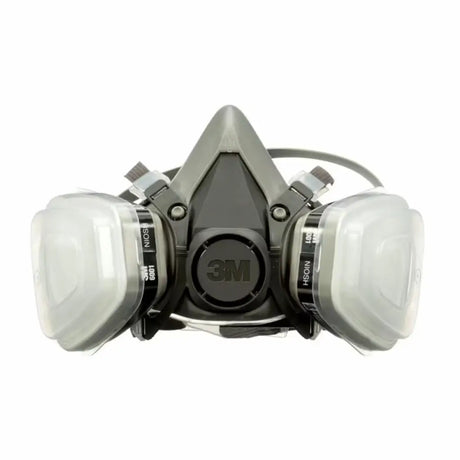 A 3M dual-face mask with a gray and black central respirator body, two clear plastic filter canisters on either side, and black straps, shown on a plain white background.
