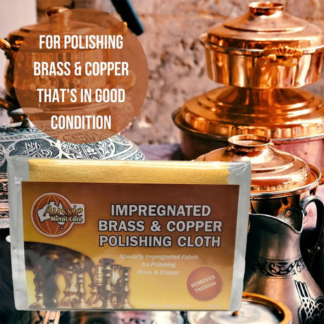 Impregnated brass and copper polishing cloth with polished brass and copper items in the background.