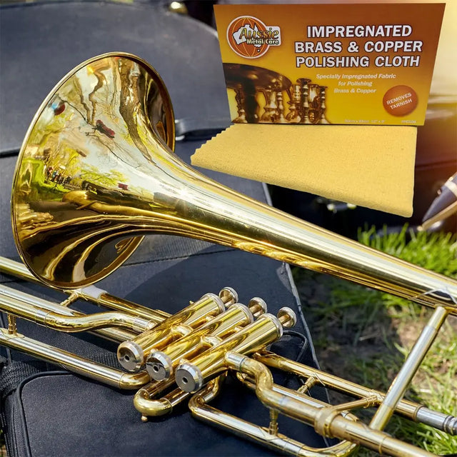 Gold trumpet with a polishing cloth and packaging in the background