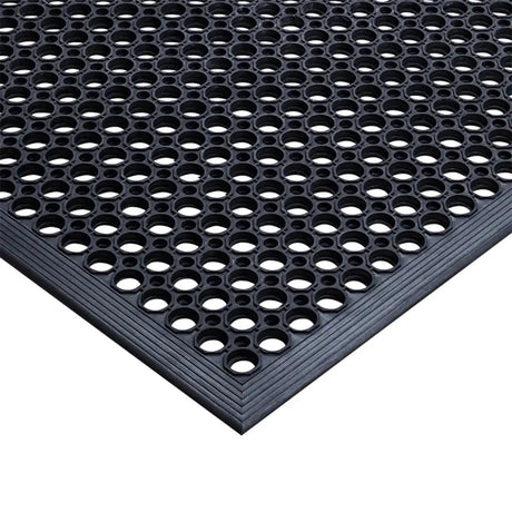 Black textured mat with circular holes on a white background