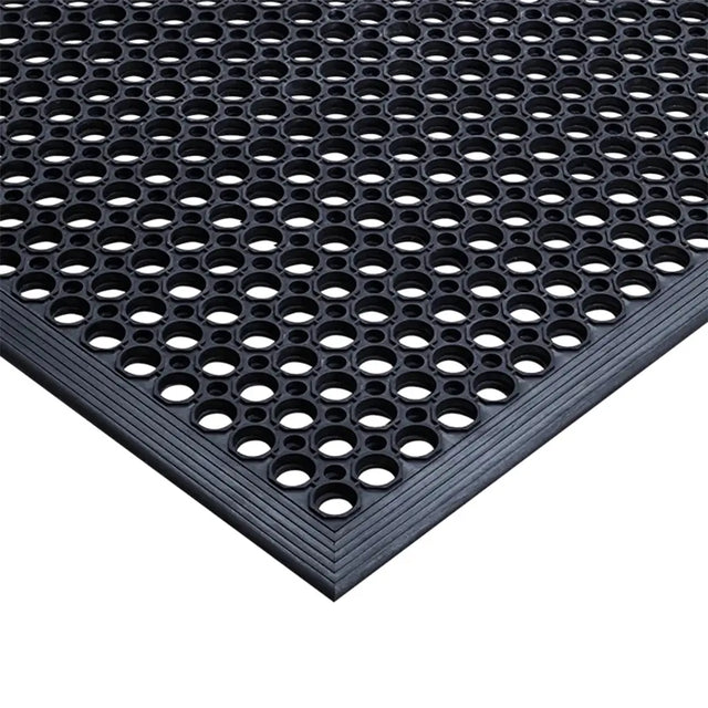 Black textured mat with circular holes on a white background