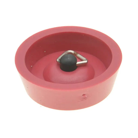 Red silicone mold with a black and silver object inside on a white background