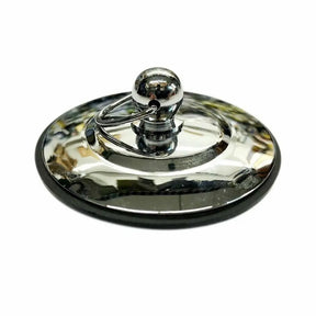 Metallic lid with a spherical handle on a white background