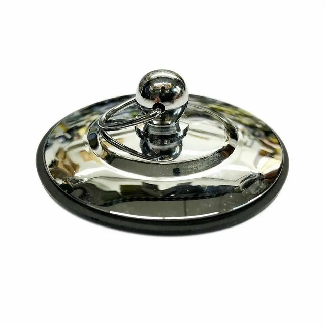 Metallic lid with a spherical handle on a white background