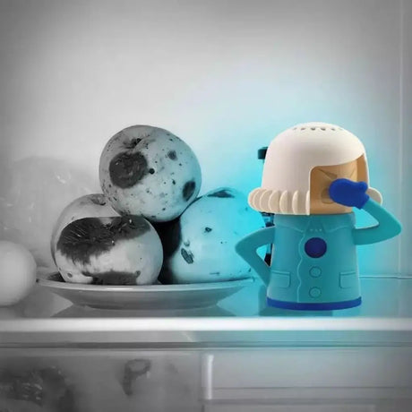 Toy figure of a character in a space suit with a bowl of soap bubbles on a reflective surface.
