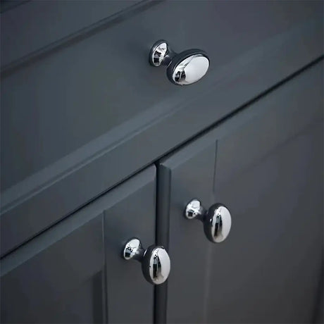 Close-up of dark gray cabinet with chrome knobs
