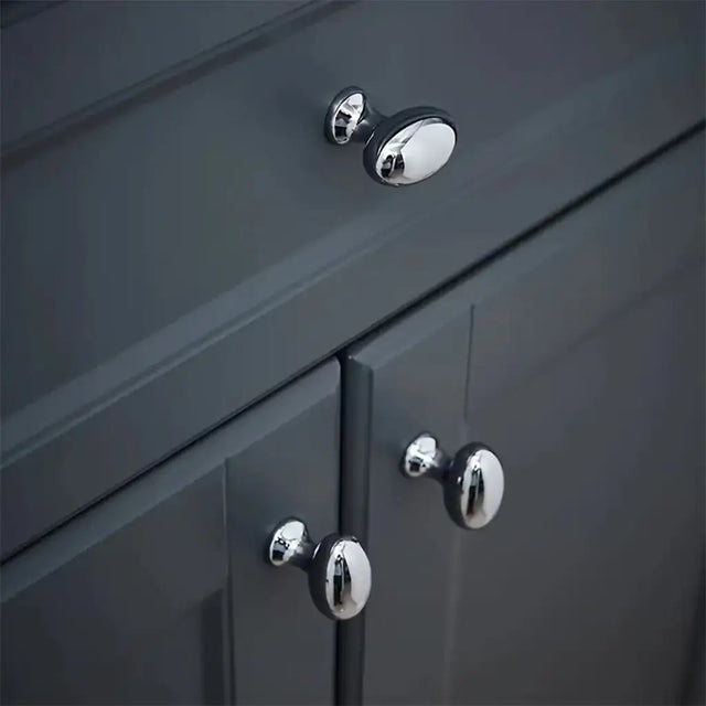 Close-up of dark gray cabinet with chrome knobs