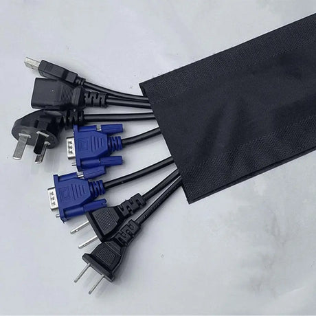 Set of various electrical plugs and a black fabric bag on a light gray background