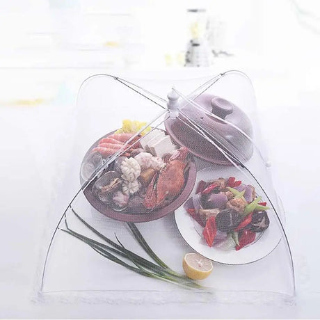 Transparent food cover with cooked seafood and vegetables on a white background