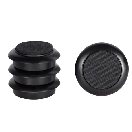 Black rubber bungs with textured surface on a white background