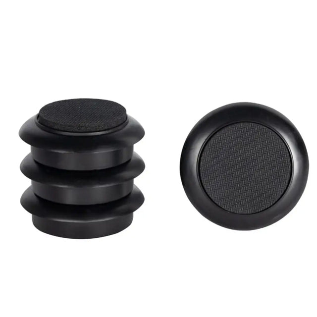 Black rubber bungs with textured surface on a white background