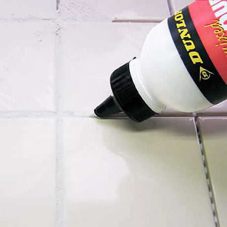 Bottle of DuPont Loctite adhesive on a tiled surface