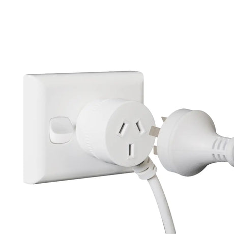 White electrical outlet with a plug inserted on a white background