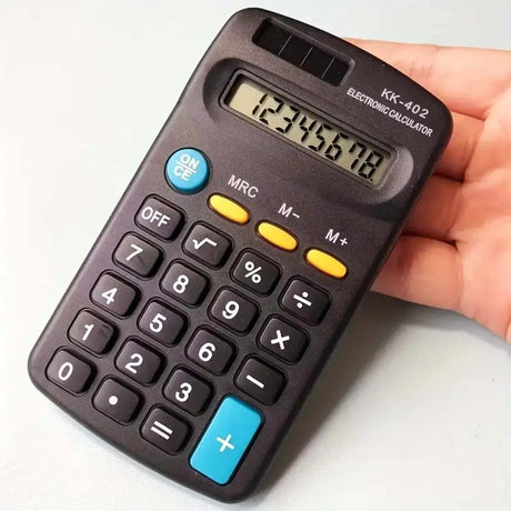 Hand holding a small calculator with a white background