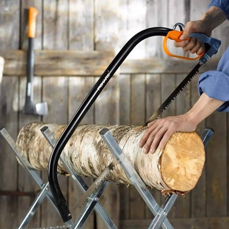 man use bow saw cut thick wood