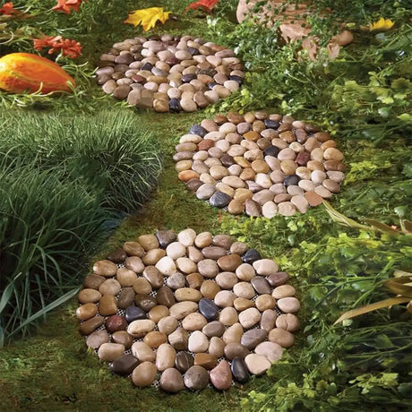 Decorative pebble path winding through grass and flowers