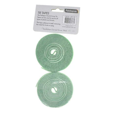 Two rolls of green tie tapes with a Feldspar brand label on a white background
