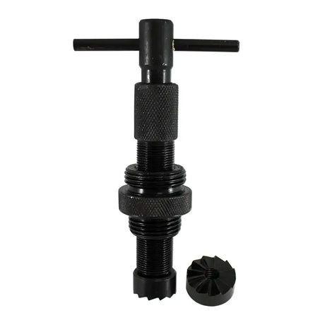 A black metal threaded tool with a T-handle on top and a separate small circular component placed beside it, shown on a plain white background.