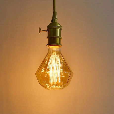 Vintage-style light bulb with a warm glow against a soft background