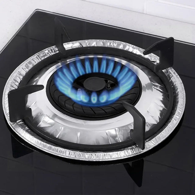 Gas stove with blue flames and a foil cover on a white background