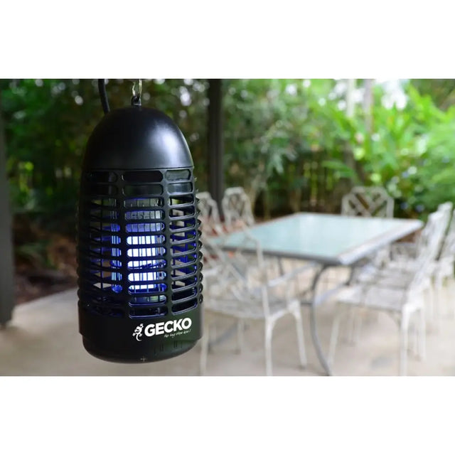 Black insect repellent lamp with 'Gecko' branding on a patio background