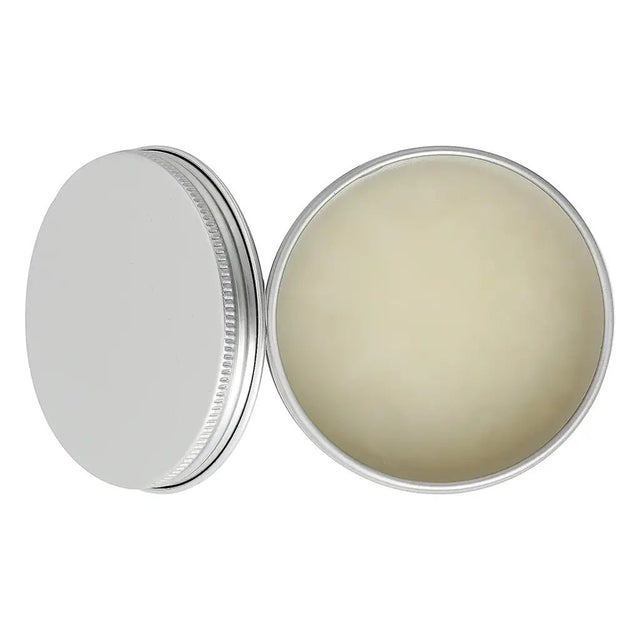 Metallic tin with a lid open, revealing a beige substance inside on a white background